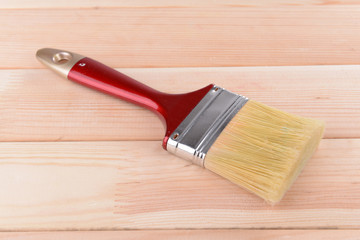 Applying protective varnish to wooden board close-up