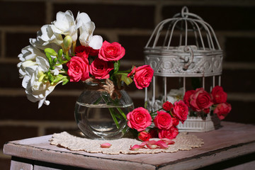 Beautiful still life with small pink roses and freesia flowers