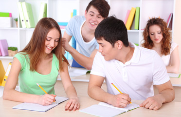 Group of young students sitting in class