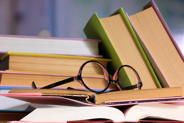 Composition with glasses and books,