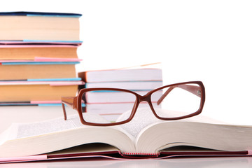 Composition with glasses and books, isolated on white