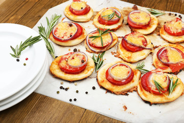 Small pizzas on baking paper close up