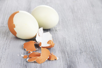 Peeled boiled egg on wooden background