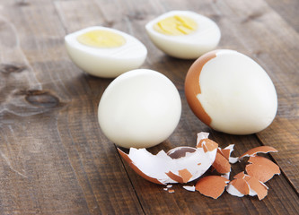 Peeled boiled egg on wooden background