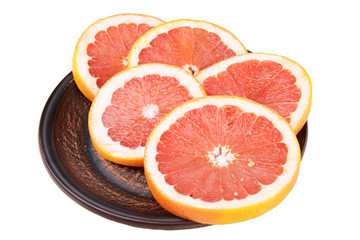 Ripe grapefruit on plate isolated on white