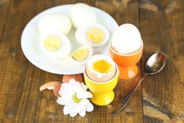 Boiled eggs on color wooden background