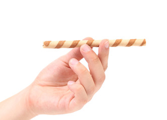 Hand holds a waffle roll with chocolate cream