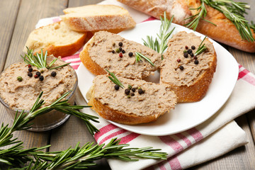 Fresh pate with bread on wooden table