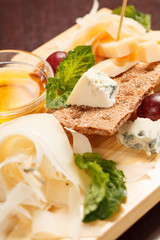 Cheese plate with grapes and honey