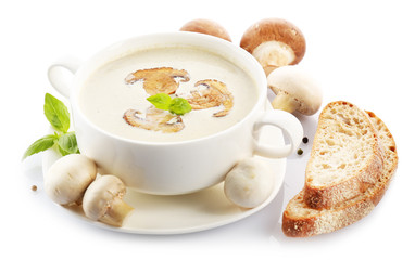 Mushroom soup in white bowl, on plate, isolated on white