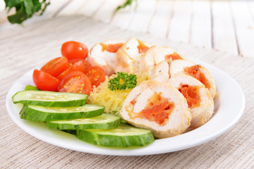 Delicious chicken roll on plate on table close-up