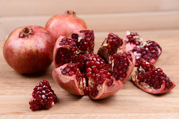 Ripe pomegranates on table close-up