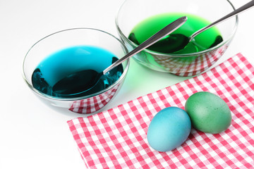 Bowls with paint for Easter eggs and eggs, isolated on white