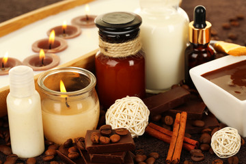 Beautiful chocolate spa setting on wooden table close-up