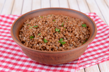 Boiled buckwheat in bowl on table close-up