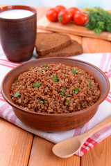 Boiled buckwheat in bowl on table close-up