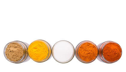 Salt and various spices over white background