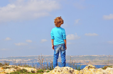 Lonely boy at the cliff edge