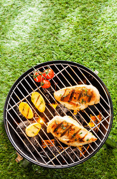 Healthy summer BBQ with chicken on the coals