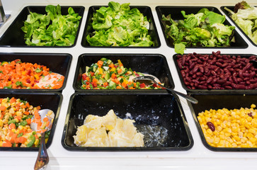 Salad  in a buffet line .