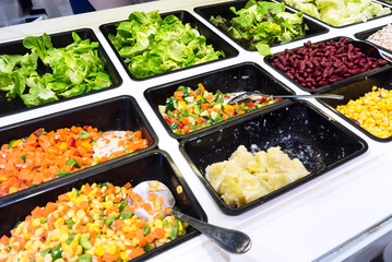 Salad  bar  in a buffet line .