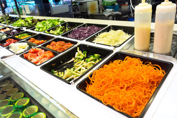 Salad  in a buffet line .