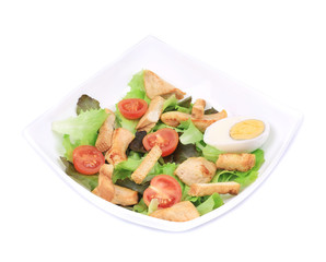 Caesar salad with eggs and tomatoes.