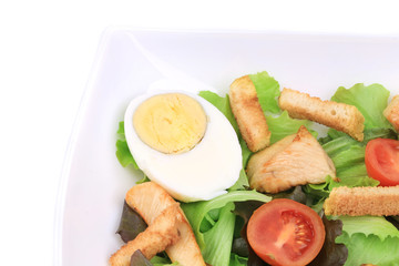 Caesar salad with eggs and tomatoes.