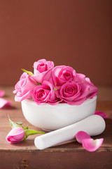 mortar with rose flowers for aromatherapy and spa