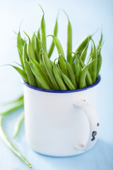 fresh green beans in white cup