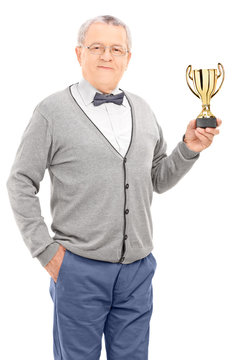 Mature man holding a trophy