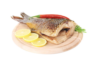 Fried fish tail on wooden table