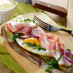 Bacon and fried eggs open sandwich