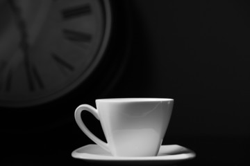 cup of coffe with clock on background black and white