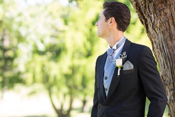 Groom looking away in garden