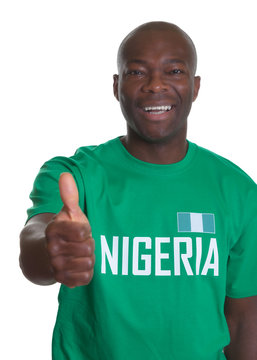 Lachender Fussball Fan aus Nigeria zeigt den Daumen