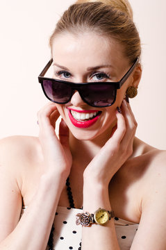 Beautiful blond pinup woman with sunglasses