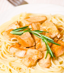 Sliced fried chicken fillet with garlic and rosemary. 