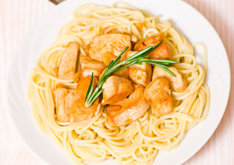Sliced fried chicken fillet with garlic and rosemary. 
