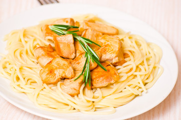 Sliced fried chicken fillet with garlic and rosemary. 