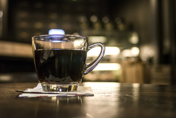 Black coffee on wood table in cafe