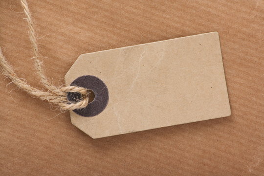 Brown Luggage Tag on Brown Wrapping Paper