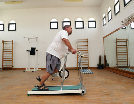 Overweight Man Running On Trainer Treadmill