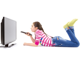 Happy little girl laying down and watching tv © manaemedia