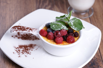 Creme brulee and coffee on a wooden table