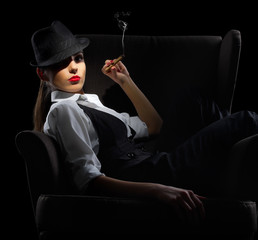 Young woman with cigar sit on chair