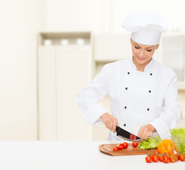 smiling female chef chopping vagetables