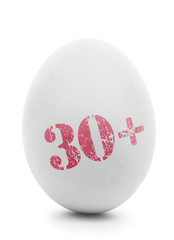 White egg with pink stamp 30+ isolated on white