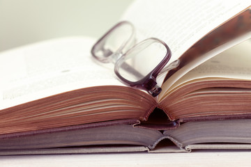 glasses and open books on the table