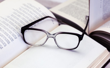 glasses and open books on the table